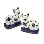 A PAIR OF VICTORIAN STAFFORDSHIRE POTTERY MODELS OF RECUMBENT CATS CIRCA 1850