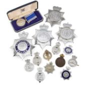 AN ELIZABETH II POLICE LONG SERVICE AND GOOD CONDUCT MEDAL AND POLICE HELMET PLATES AND BADGES