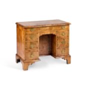 AN EARLY 18TH CENTURY CROSS-BANDED WALNUT KNEEHOLE DESK
