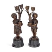 A PAIR OF PATINATED BRONZE FIGURAL CANDLESTICKS