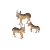A SET OF THREE ITALIAN SILVER AND ENAMEL MODELS OF DONKEYS