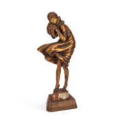 AN ART DECO STYLE PATINATED METAL AND FAUX IVORY FIGURE