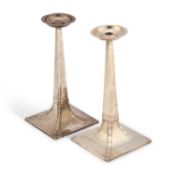 A NEAR PAIR OF ARTS AND CRAFTS SILVER LAMP BASES