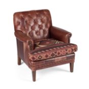 A BROWN LEATHER BUTTONED BACK ARMCHAIR