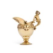 AN EDWARDIAN SILVER-GILT CREAM EWER