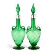 A PAIR OF LATE VICTORIAN SILVER-MOUNTED GREEN-GLASS DECANTERS AND STOPPERS