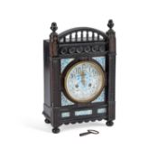 AN AESTHETIC MOVEMENT EBONISED MANTEL CLOCK IN THE STYLE OF LEWIS FOREMAN DAY