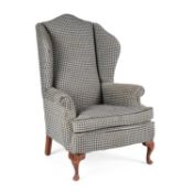 A LARGE UPHOLSTERED WING-BACK ARMCHAIR