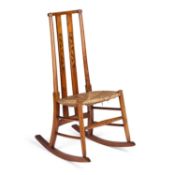 AN ARTS AND CRAFTS INLAID STAINED BEECH ROCKING CHAIR