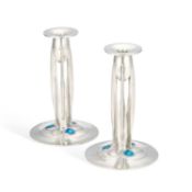 ARCHIBALD KNOX (1864-1933) FOR LIBERTY & CO A PAIR OF TUDRIC PEWTER AND ENAMEL CANDLESTICKS