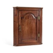 A GEORGE III OAK HANGING CORNER CUPBOARD