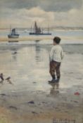 RICHARD ELLIS WILKINSON (1854-1891) BOY ON THE BEACH, FISHING BOATS BEYOND