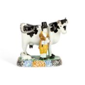 A PRATT TYPE MODEL OF A COW AND ATTENDANT CIRCA 1810