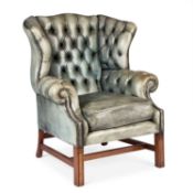 A GEORGIAN STYLE DEEP-BUTTONED LEATHER WING-BACK ARMCHAIR