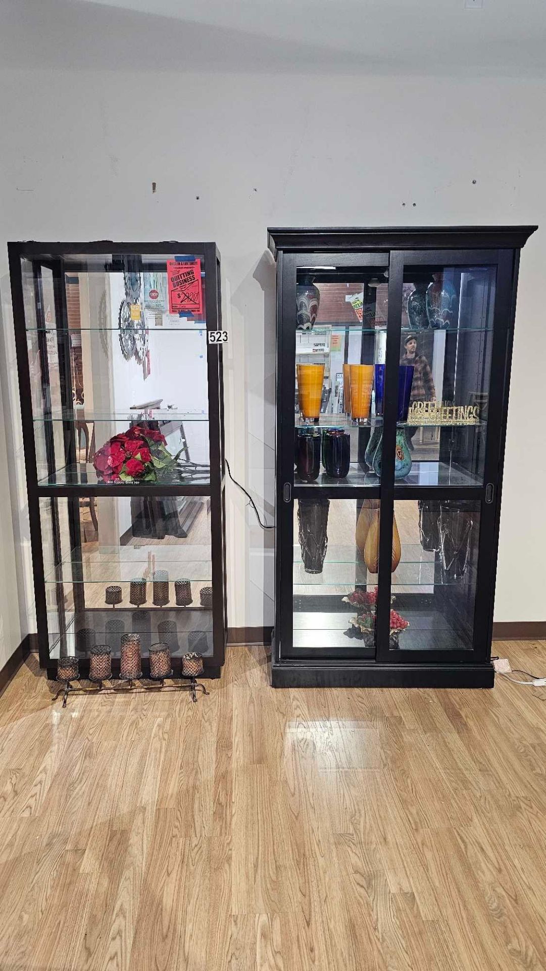 two curio cabinets with contents