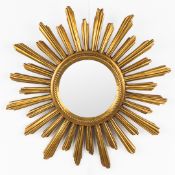A mid-century sunburst mirror, convex glass. Gilt resine. Circa 1970.