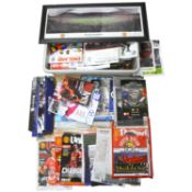 A collection of football programmes, clappers, pictures and other items