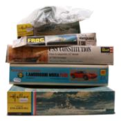 Five model ship and vehicle kits, including Heller, Otaki and Revell