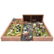 A collection of resin farmyard animals and accessories, with wooden farmyard playset
