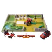 Large collection of Britains farming vehicles, figures, and layouts