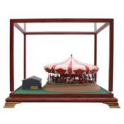 Two kit built models, including a fairground carousel, and HMS Rodney, both in display cases.