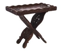 An Anglo-Indian carved hardwood tray on folding stand