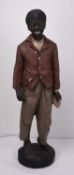 Life size polychrome plaster figure of a young black boy