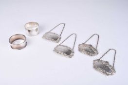 Four silver decanter labels and two silver napkin rings