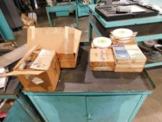 Assorted Grinding Wheels in cabinet and on wall