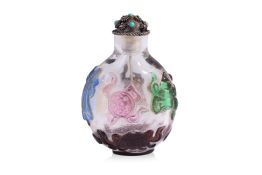 A MULTI-COLOURED OVERLAY AND CLEAR GLASS 'BUDDHIST EMBLEM' SNUFF BOTTLE