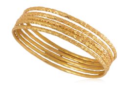 A GROUP OF FIVE HIGH KARAT GOLD BANGLES