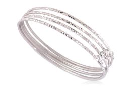 A GROUP OF FOUR WHITE GOLD BANGLES