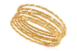 A GROUP OF SIX HIGH KARAT GOLD BANGLES