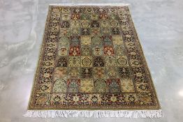 A FINE PANELLED WOOL RUG (211 x 140cm)