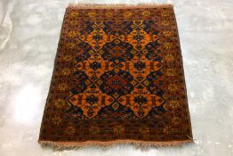 A SMALL TRIBAL WOOL RUG