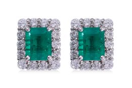 A PAIR OF EMERALD AND DIAMOND 'HALO' STUD EARRINGS