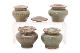 A GROUP OF FOUR LONGQUAN CELADON LOTUS JARS AND COVERS