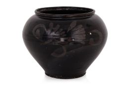 A LARGE BLACK GLAZED JAR