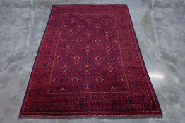 A TURKMAN TRIBAL WOOL CARPET (299 x 203cm)