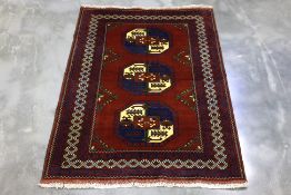 AN AFGHAN FIL POI WOOL RUG (174 x 125 cm)
