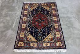 A KASHMIRI MEDALLION WOOL RUG 182 x 124