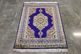 A KASHMIRI WOOL RUG (183 x 129cm)