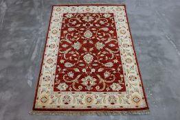 AN AFGHAN REZA WOOL RUG (192 x 125cm)