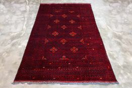 A TURKMEN TRIBAL WOOL CARPET (305 x 198cm)