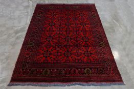 AN AFGHAN WOOL CARPET (292 x 209cm)