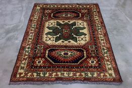 AN AFGHAN WOOL RUG (224 x 178cm)