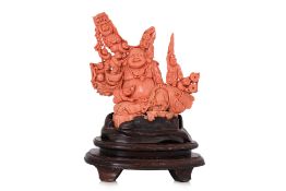 A LARGE CORAL CARVING OF BUDAI AND BOYS