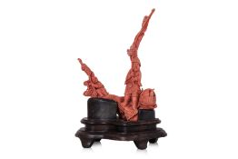 A CORAL CARVING OF A FISHERMAN AND A BOY