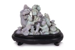 A LARGE CARVED JADEITE GROUP OF A MYTHICAL BEAST AND BOYS