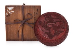 A CARVED CINNABAR CIRCULAR LACQUER BOX AND COVER